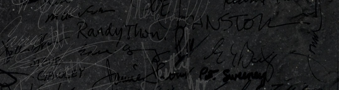 Close-up of celebrity signatures on a dark background